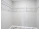 Spacious walk-in closet featuring ample storage shelving and neutral wall paint at 7140 Teaberry St, Englewood, FL 34224