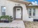 Close-up of the front door with modern hardware and landscaping at 7140 Teaberry St, Englewood, FL 34224