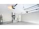 Spacious garage with an electric water heater, ladder, and other utilities at 7140 Teaberry St, Englewood, FL 34224