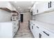 Modern kitchen with white cabinets, quartz countertops, and stainless steel appliances at 7140 Teaberry St, Englewood, FL 34224