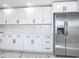 A bright kitchen featuring stainless steel appliances, white cabinets, and stone countertops at 7140 Teaberry St, Englewood, FL 34224