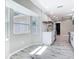 Eat-in kitchen with lots of natural light, featuring white cabinets, stainless steel appliances, and wood-look flooring at 7140 Teaberry St, Englewood, FL 34224