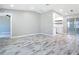 Spacious living area with modern flooring, neutral walls, and stylish recessed lighting at 7140 Teaberry St, Englewood, FL 34224