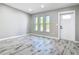 Inviting living room featuring new flooring, neutral paint, and plenty of natural light at 7140 Teaberry St, Englewood, FL 34224