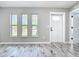 Bright living room with modern flooring, fresh paint, and ample natural light at 7140 Teaberry St, Englewood, FL 34224