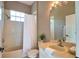 Comfortable bathroom with a vanity, shower-tub combo, and a window for natural light at 8209 Snowy Egret Pl, Bradenton, FL 34202