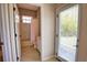 Well lit bathroom includes a shower-tub combo with tile surround and a door to the backyard at 8209 Snowy Egret Pl, Bradenton, FL 34202