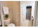 Cozy bathroom featuring a toilet, shower-tub combo, and neutral color palette at 8209 Snowy Egret Pl, Bradenton, FL 34202