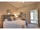 Cozy bedroom with neutral tones, ceiling fan, and an ensuite bathroom entrance at 8209 Snowy Egret Pl, Bradenton, FL 34202