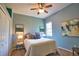 Cozy bedroom with serene blue walls, plush carpet, and a ceiling fan at 8209 Snowy Egret Pl, Bradenton, FL 34202