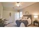 Inviting bedroom with a comfortable bed, neutral decor, a ceiling fan, and carpet flooring at 8209 Snowy Egret Pl, Bradenton, FL 34202