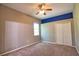 Neutral carpeted bedroom featuring a ceiling fan, double closet, and natural light at 8209 Snowy Egret Pl, Bradenton, FL 34202