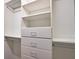 Walk-in closet with built-in shelving and drawers for optimal organization at 8209 Snowy Egret Pl, Bradenton, FL 34202