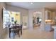 Cozy dining area with a view of the screened-in patio, adjacent to an open kitchen and living space at 8209 Snowy Egret Pl, Bradenton, FL 34202