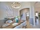 Well-lit dining room with modern chandelier, stylish decor, and a glimpse into the kitchen at 8209 Snowy Egret Pl, Bradenton, FL 34202
