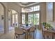 Bright dining area with a chandelier, table setting for six, and sunny views from large window at 8209 Snowy Egret Pl, Bradenton, FL 34202