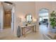 Inviting foyer with a console table, mirror, and plant, leading to a spacious living area at 8209 Snowy Egret Pl, Bradenton, FL 34202