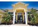 Inviting entrance with double doors, white pillars, and verdant landscaping for added privacy at 8209 Snowy Egret Pl, Bradenton, FL 34202