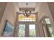 Close up of entry way, showing a chandelier and a beautiful sky view above the doors at 8209 Snowy Egret Pl, Bradenton, FL 34202