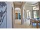 Inviting foyer featuring arched doorways, neutral tile flooring, and a view into the dining and living spaces at 8209 Snowy Egret Pl, Bradenton, FL 34202