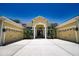 Charming home featuring a double garage and covered front entryway with pillars at 8209 Snowy Egret Pl, Bradenton, FL 34202
