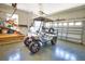 Well-organized garage featuring epoxy flooring, ample storage, and a modern golf cart at 8209 Snowy Egret Pl, Bradenton, FL 34202