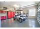 Organized garage space featuring a golf cart and ample storage cabinets at 8209 Snowy Egret Pl, Bradenton, FL 34202