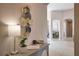 Hallway featuring a decorative wall piece, a table with a lamp, and entryways to other rooms at 8209 Snowy Egret Pl, Bradenton, FL 34202
