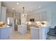 Kitchen with an island, stainless steel appliances, gray cabinets, and barstool seating at the counter at 8209 Snowy Egret Pl, Bradenton, FL 34202