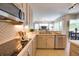 A modern kitchen with stainless steel appliances and bright countertops seamlessly connects to the living area at 8209 Snowy Egret Pl, Bradenton, FL 34202