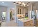Open-concept kitchen with stainless steel appliances, pendant lighting, and easy access to the dining area at 8209 Snowy Egret Pl, Bradenton, FL 34202