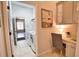 Bright laundry room with modern washer and dryer, adjacent to a home office nook at 8209 Snowy Egret Pl, Bradenton, FL 34202