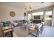 Inviting living room with a gray sectional, modern furnishings, and a bright, airy ambiance with access to the patio at 8209 Snowy Egret Pl, Bradenton, FL 34202