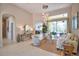 Bright living room with tiled floors, modern lighting, comfortable seating, and seamless access to outdoor living at 8209 Snowy Egret Pl, Bradenton, FL 34202