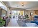 Bright living room with views of the screened-in pool area, modern furniture, and easy access to the outdoors at 8209 Snowy Egret Pl, Bradenton, FL 34202