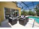 Relaxing screened patio with comfortable seating overlooks the sparkling private pool and lush landscaping at 8209 Snowy Egret Pl, Bradenton, FL 34202