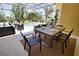 Enjoy outdoor dining on the screened patio with views of the pool and lush landscaping at 8209 Snowy Egret Pl, Bradenton, FL 34202