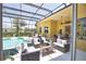 Inviting outdoor living space with a sparkling pool, comfortable seating, and a screened enclosure for year-round enjoyment at 8209 Snowy Egret Pl, Bradenton, FL 34202