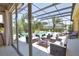 Screened-in pool area featuring a sparkling pool, comfortable lounge seating, and lush tropical landscaping at 8209 Snowy Egret Pl, Bradenton, FL 34202