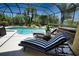 Enclosed pool featuring comfortable lounge chairs and tropical landscaping at 8209 Snowy Egret Pl, Bradenton, FL 34202