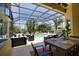 Enclosed pool area featuring outdoor seating, lush landscaping, and a pristine pool at 8209 Snowy Egret Pl, Bradenton, FL 34202