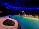 Private pool lit with vibrant blue lights and tropical landscaping at 8209 Snowy Egret Pl, Bradenton, FL 34202