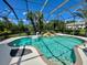 Sparkling pool with lush landscaping and a serene waterfall feature at 8209 Snowy Egret Pl, Bradenton, FL 34202