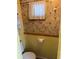 This bathroom features bright yellow walls, neutral wallpaper, and updated fixtures at 834 Cervina S Dr, Venice, FL 34285