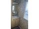 Bathroom featuring wallpaper with a tropical print and updated sink and faucet fixtures at 834 Cervina S Dr, Venice, FL 34285