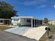 Charming single-story home with a covered parking area and well-maintained lawn at 834 Cervina S Dr, Venice, FL 34285