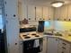 Efficient kitchen space featuring updated appliances, white cabinets, and ample natural light at 834 Cervina S Dr, Venice, FL 34285