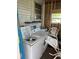 View of a laundry room featuring a washing machine, drying machine, and a utility sink at 834 Cervina S Dr, Venice, FL 34285