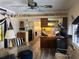 Open floor plan connecting the living room and kitchen, featuring decor and wood-look flooring at 834 Cervina S Dr, Venice, FL 34285