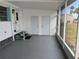 The screened porch with access to the front entrance at 834 Cervina S Dr, Venice, FL 34285